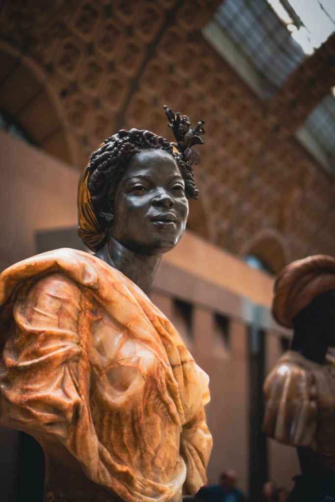 Sculpted portrait of an African woman displayed in a museum