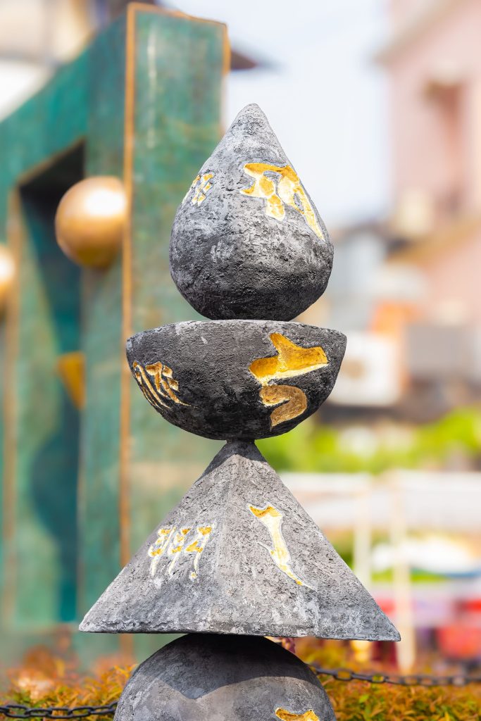 Abstract stone sculpture with gold details