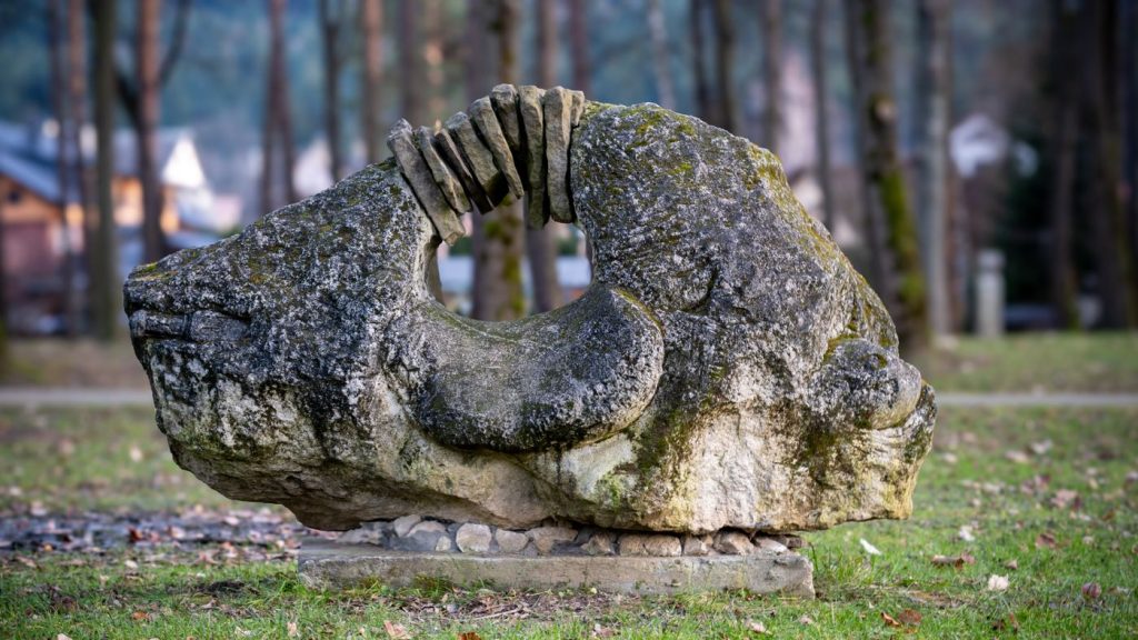 Weathered stone sculpture resting in a park