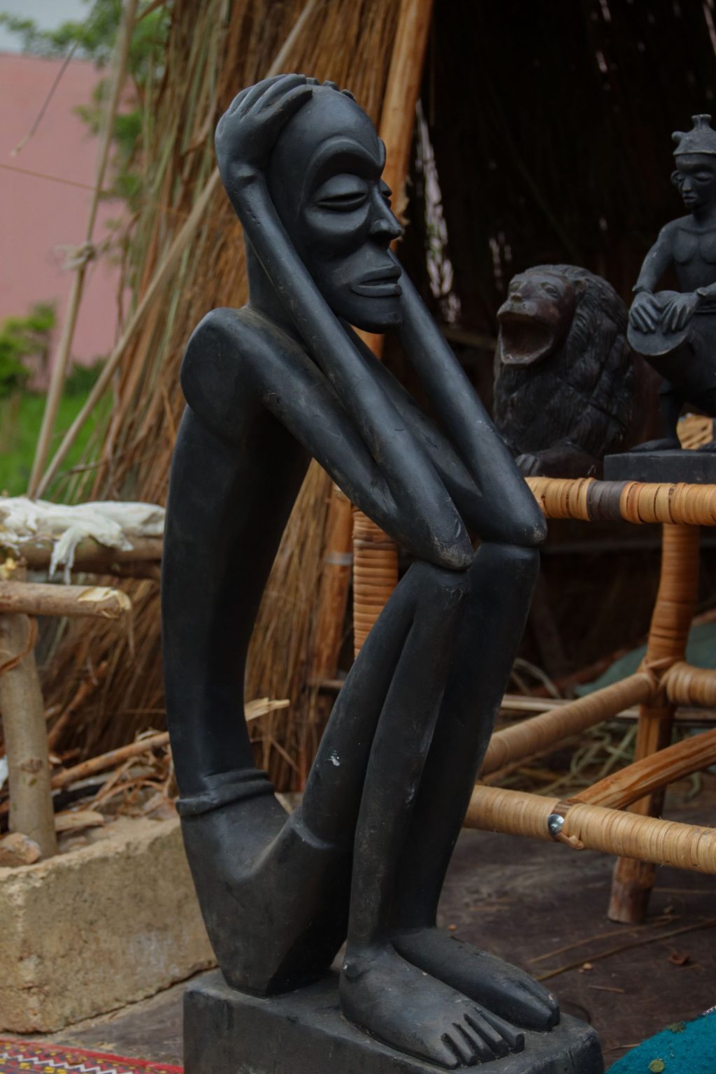 Dark polished African stone sculpture of a figure