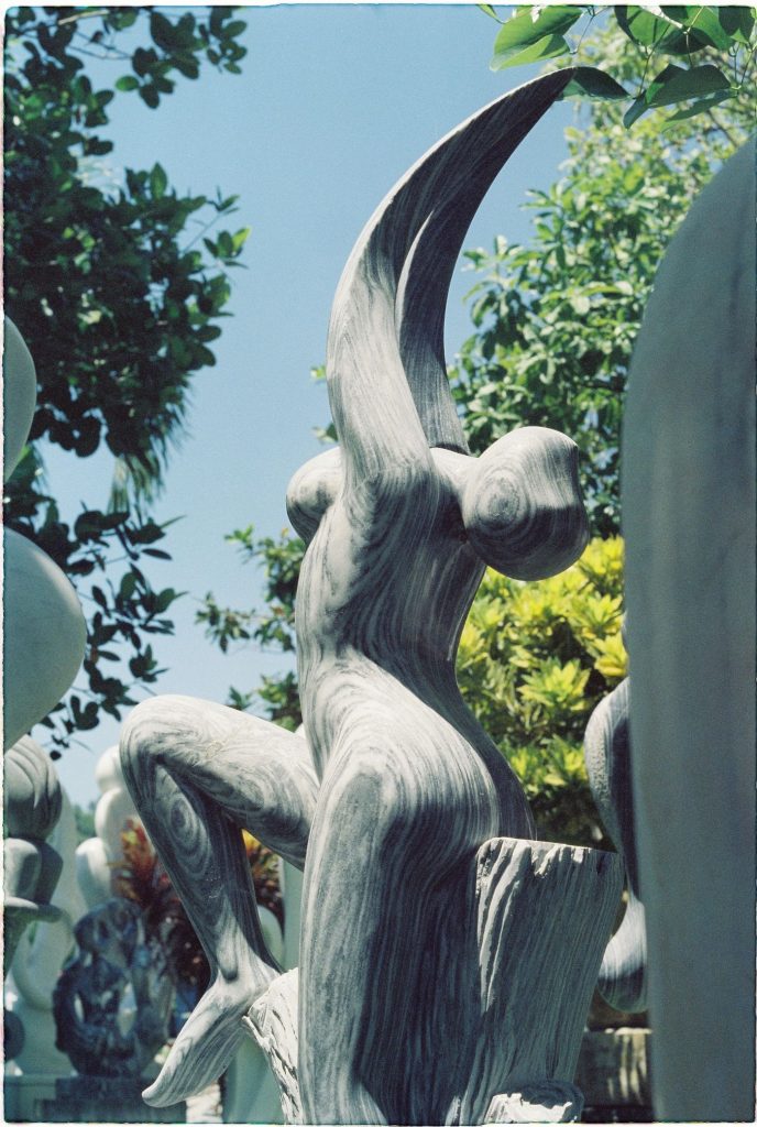 Abstract stone sculpture with flowing curves outdoors